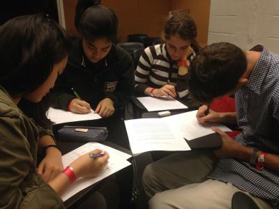 Columbia Students grading high school student's test for the Columbia Math Majors of America Tournament for High Schools.