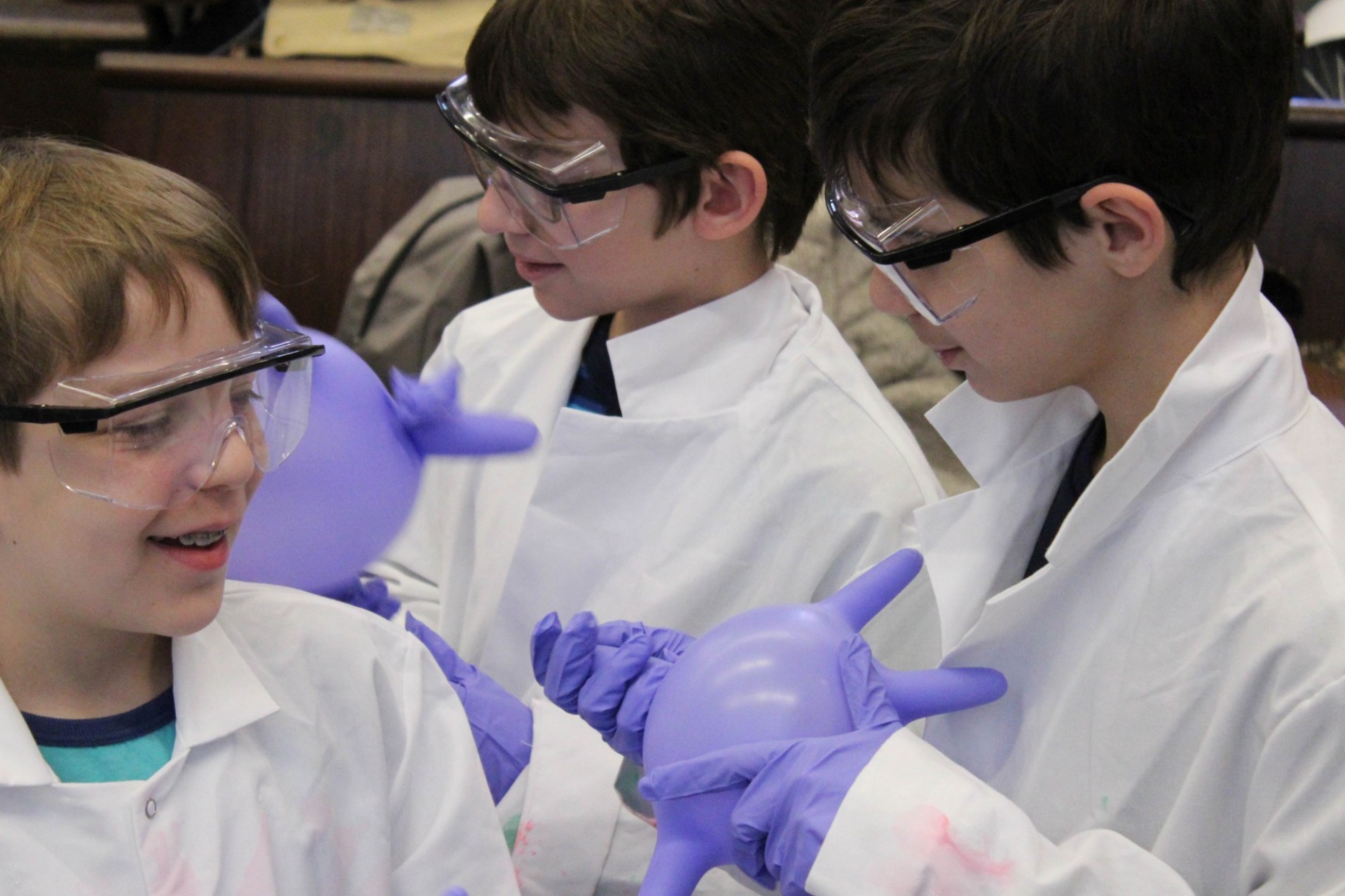 Kids making bouncy balls during a demo on polymers. Photo Credit: Outreach Programs Staff Kids making bouncy balls