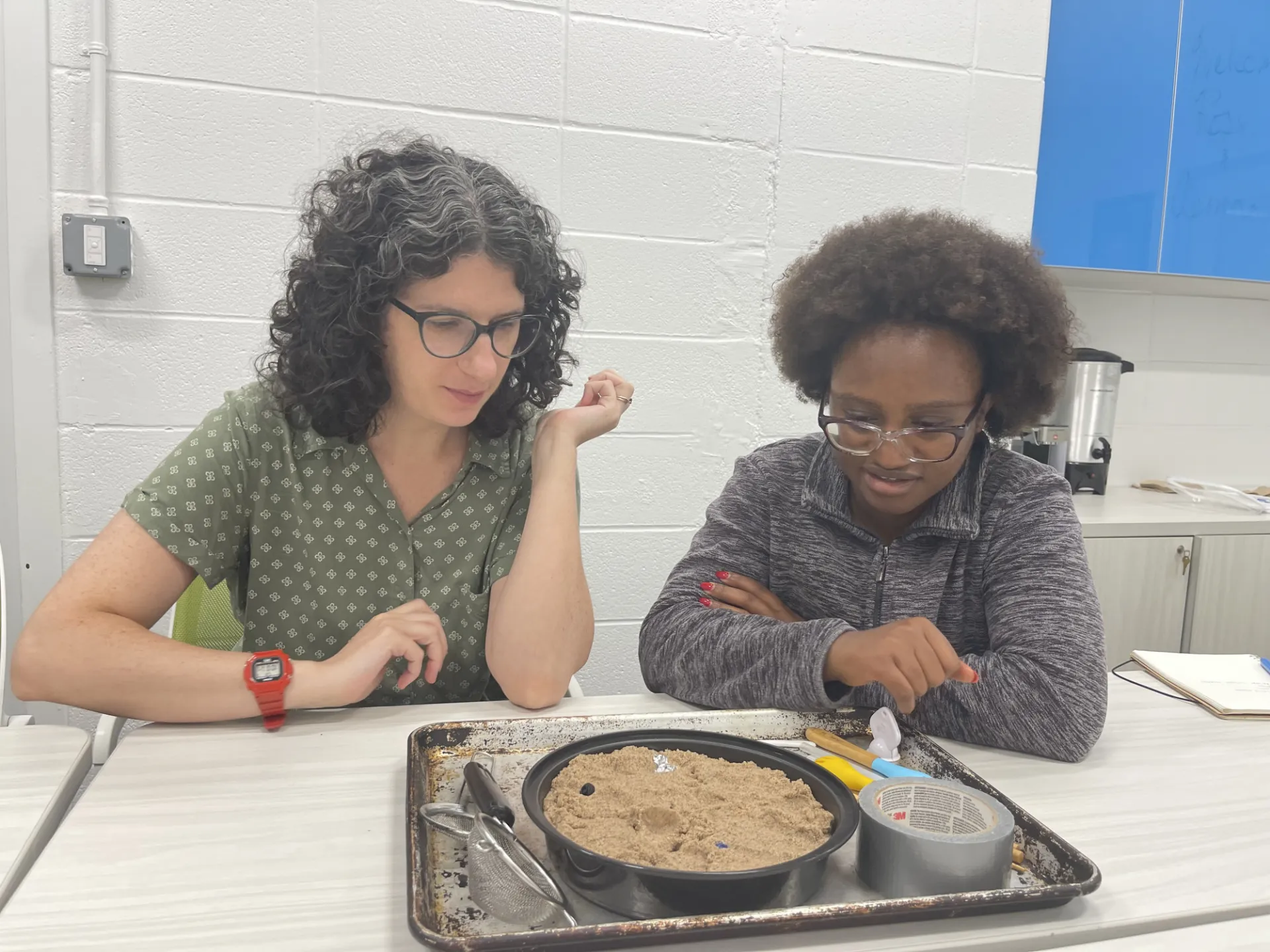 The 2026 ECO-CBET researchers practicing a hands-on demo simulating sorting materials in a landfill.