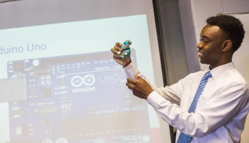 An E.N.G. student displays an arduino used in his research